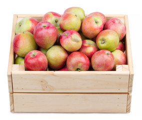 Wooden box full of fresh apples isolated on a white