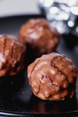 Sweets and desserts, round chocolate sweets with nut cream filling , macro