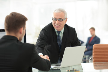 businessman welcomes business partner shaking hands