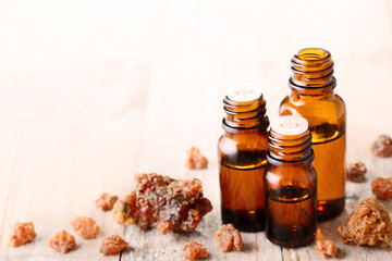 Myrrh essential oil and myrrh on the wooden board