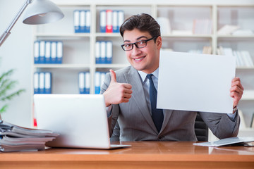 Businessman  in office holding a blank message board