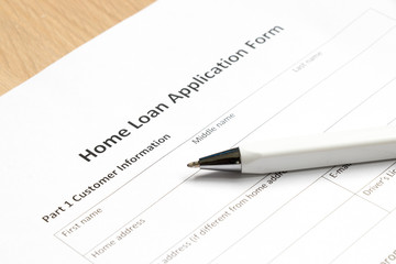 Home loan application form with pen on desk background