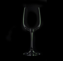 Silhouette of glass, isolated on black with green illumination