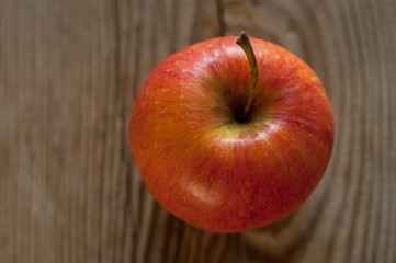 Ripe red apple on rustic dark wooden table