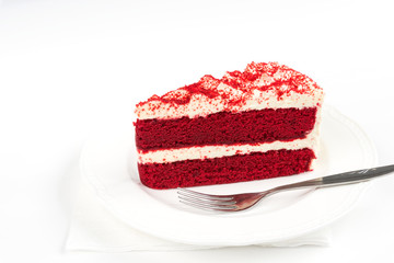 Red Velvet Cake sliced in piece on white plate with fork on white background for celebrate X'mas season, Valentines day, birthday or special holiday events