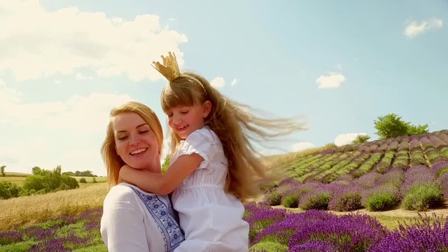 Family in lavender field, mother and daughter having fun