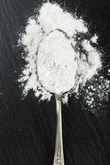 silver spoon with flour