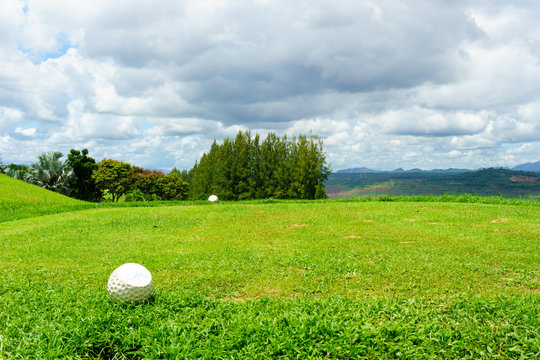 tee off with forest and blue sky and cloud background.