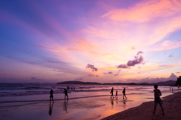 Fototapeta premium Sun set at beach with beautiful sky, people walking and enjoying at the beach