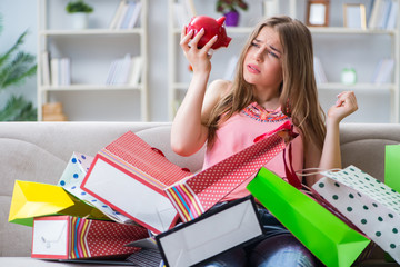 Young woman with shopping bags indoors home on sofa