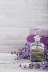 Bottle of essential oil and fresh lavender flowers