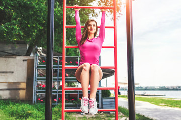 Cute sporty girl workout outdoor on the sports ground