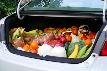 open car trunk full of fresh food from grocery store