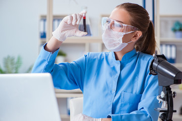 Female scientist researcher conducting an experiment in a labora