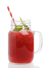 Freshly made smoothies of watermelon in a glass jar on a white background