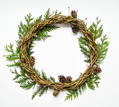 Festive wreath of vines with thuja branches and cones. Flat lay, top view