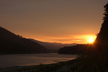 Sunset on the mountain river. Chaya river, North Baikal Highlands, Siberia, Russia.