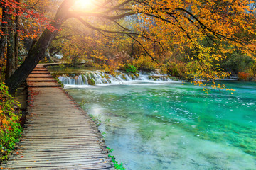 Beautiful tourist pathway in colorful autumn forest, Plitvice lakes, Croatia