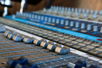 Close up of audio mixer knobs