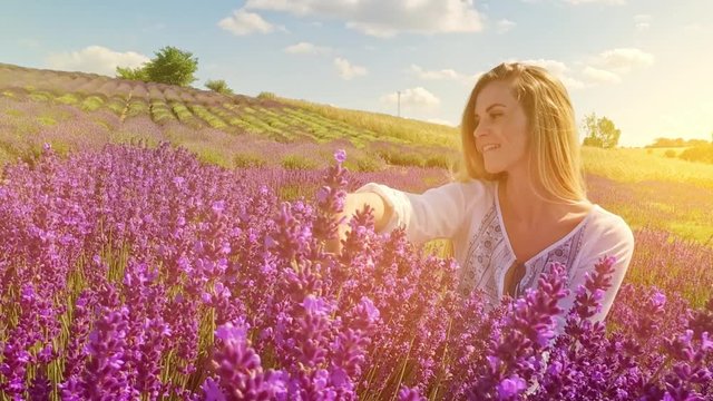 Lovely cute woman in lavender field at sunny day freedom concept