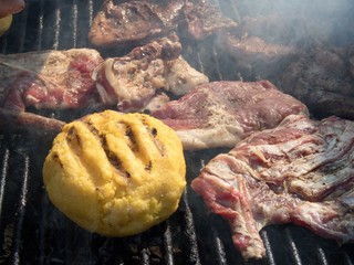 traditional romanian bulz cheese warped polenta with sheep pastrami on the grill