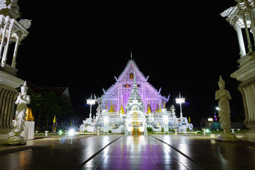 landscape view of ancient burmese style chiang rai temple turning color light on at night. lampang,...