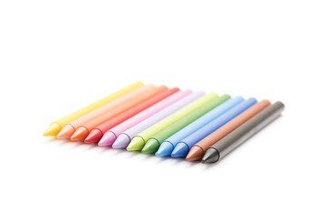 Group of colored crayons on white background side view