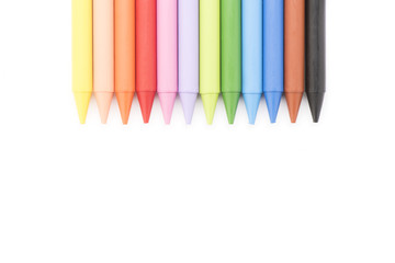 Group of colored crayons on white background top view