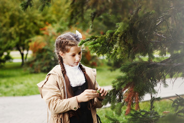 Beautiful girl in the warm autumn light with golden leaves on trees