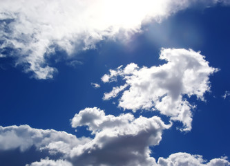 Blue sky with fluffy white clouds in day light