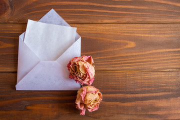 Blank card and envelope on old wooden background
