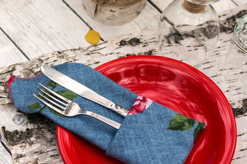 metal fork and knife wrapped in blew napkin close up view