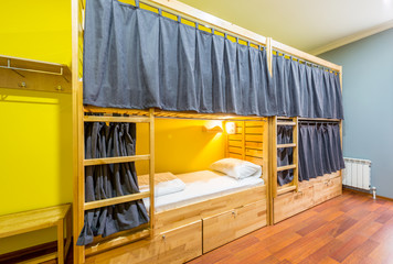 Hostel dormitory beds arranged in room
