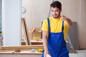 Young repairman carpenter working cutting wood