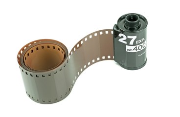 A roll of 35mm camera film on a white background