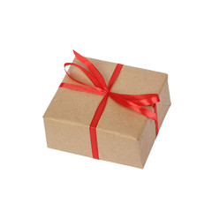 Gift box wrapped in brown recycled paper with red ribbon bow top view isolated on white background, clipping path included