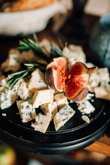 decorated tables with plates of cheese, baskets of bread, candles, candlesticks, flowers, bouquet, jam