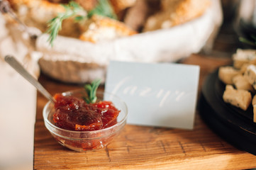 plates with jam, bread basket on background