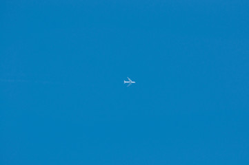 four engine passenger plane alone in cloudless blue sky