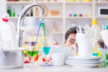 Man frustrated at having to wash dishes