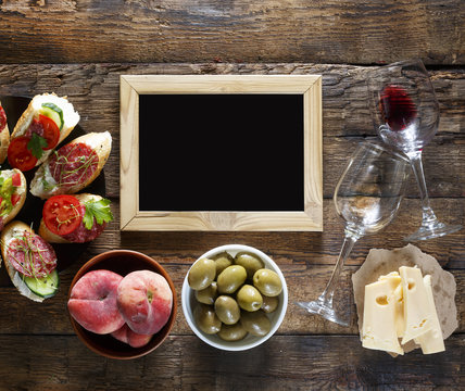 Wine and traditional Italian and American snacks. Salami, cheese, olives, brusquets, microgrin