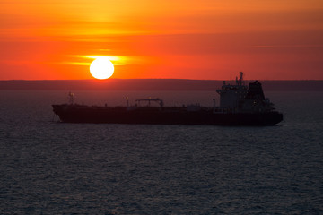 Crago ship at anchor when it sunset.