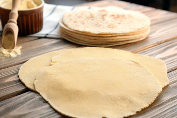 Rolled dough for tortillas on kitchen table