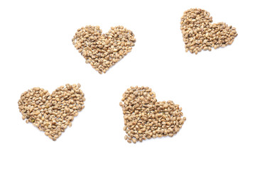 Hearts made of hemp seeds on white background