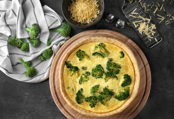 Composition with tasty broccoli quiche on table