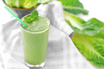 Healthy smoothie with kale in glass on table