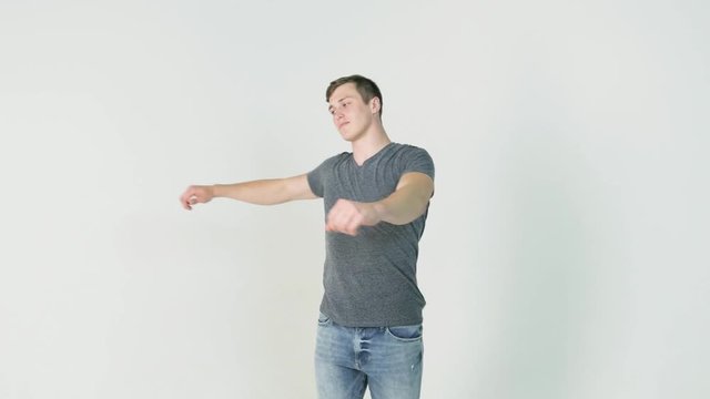 Young smiling man athlete doing warming exercises on white background. Concept of sport, health, keeping fit