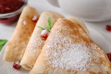 Delicious pancakes with berries on plate, closeup