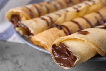 Delicious pancakes with chocolate sauce, closeup