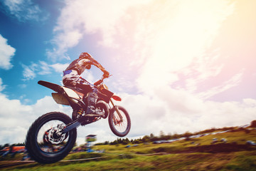 Racer on motorcycle participates and jumps. Close-up. concept of extreme motocross, sports racing....